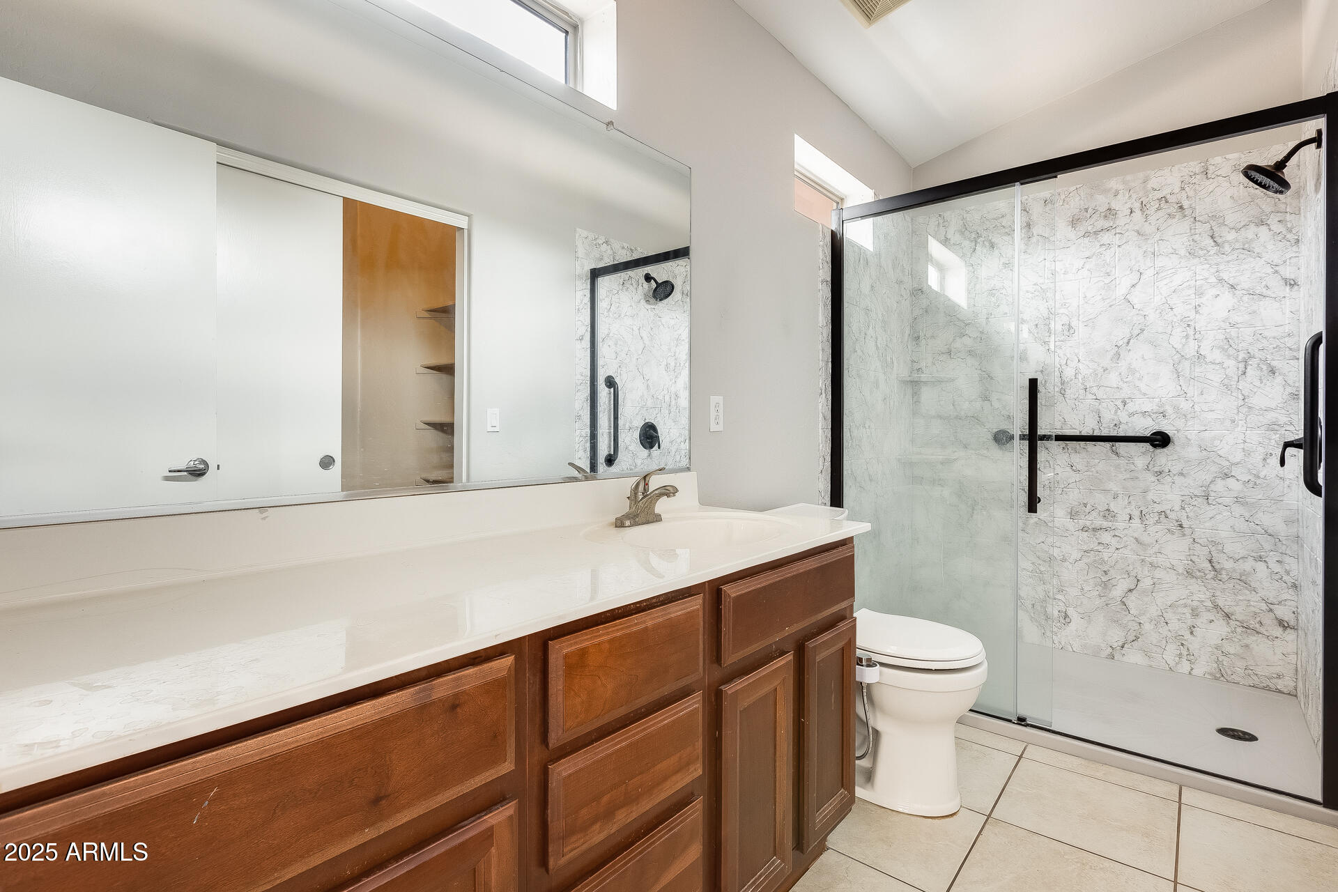 2024 South Baldwin, Unit 113 Mesa, AZ 85209 - Photo 13 of 28 a bathroom with a sink toilet a mirror and shower