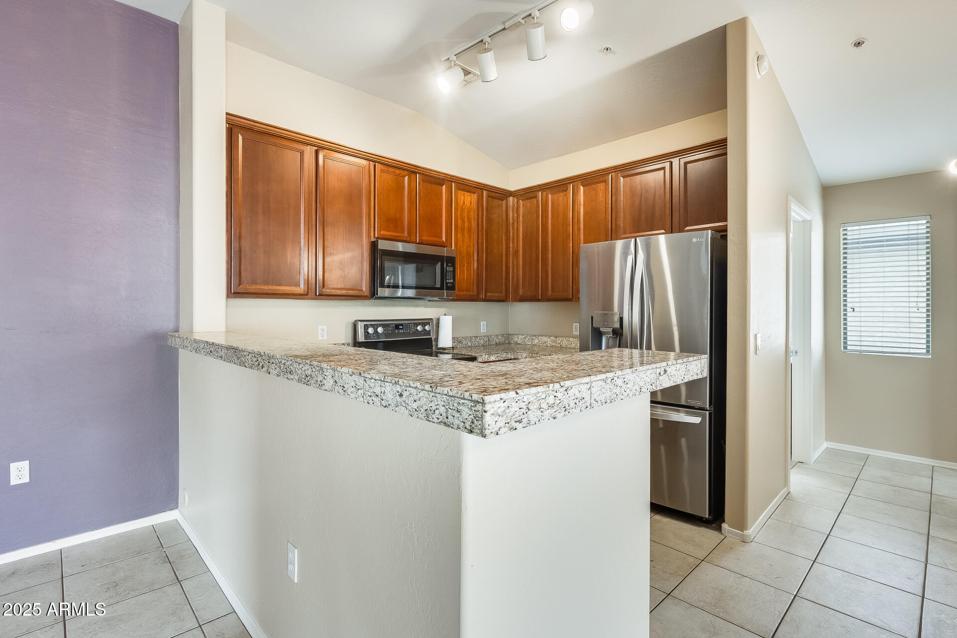 2024 South Baldwin, Unit 113 Mesa, AZ 85209 - Photo 21 of 28 a kitchen with stainless steel appliances granite countertop a refrigerator a stove a sink and a microwave