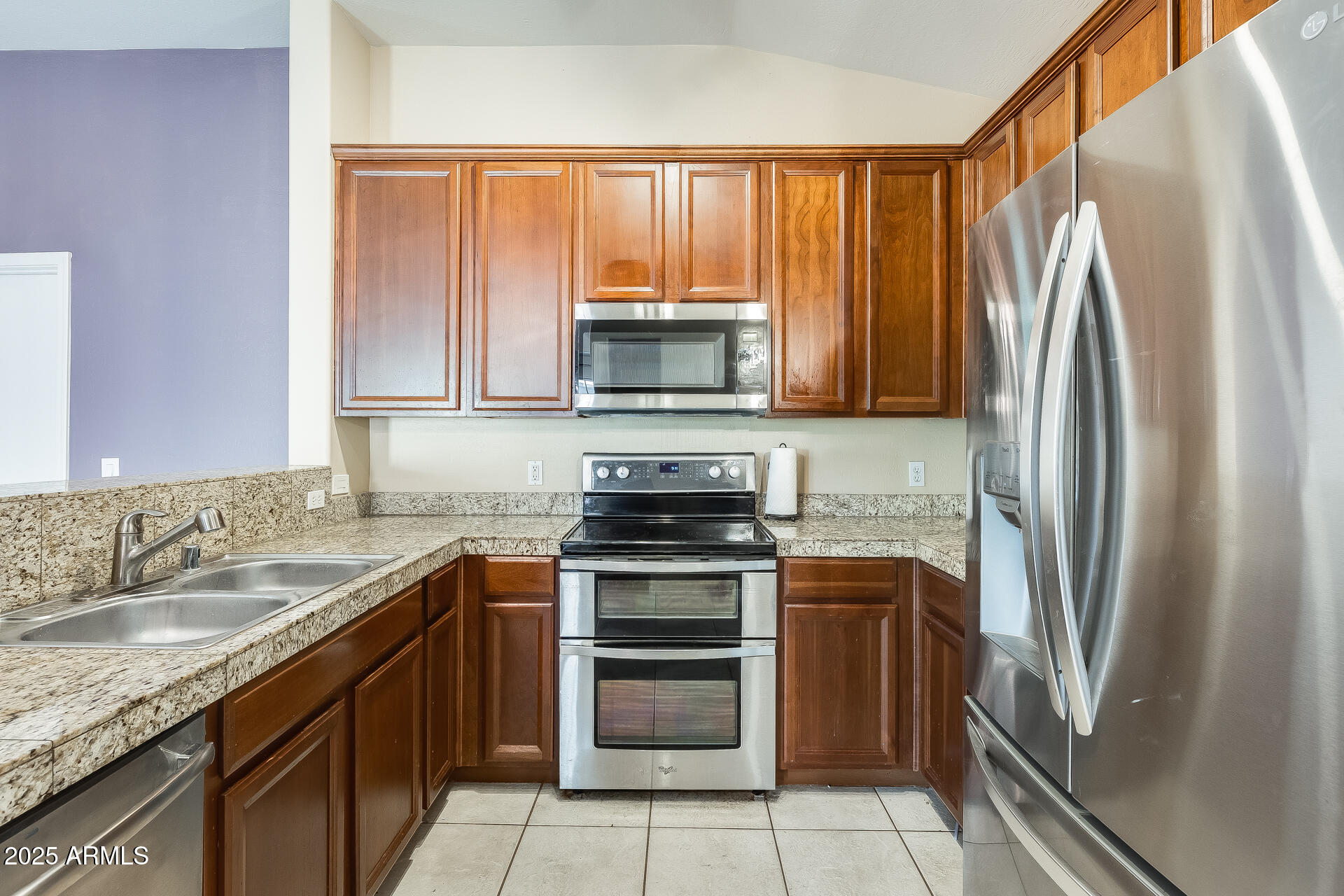 2024 South Baldwin, Unit 113 Mesa, AZ 85209 - Photo 9 of 28 a kitchen with a stove a sink and a refrigerator