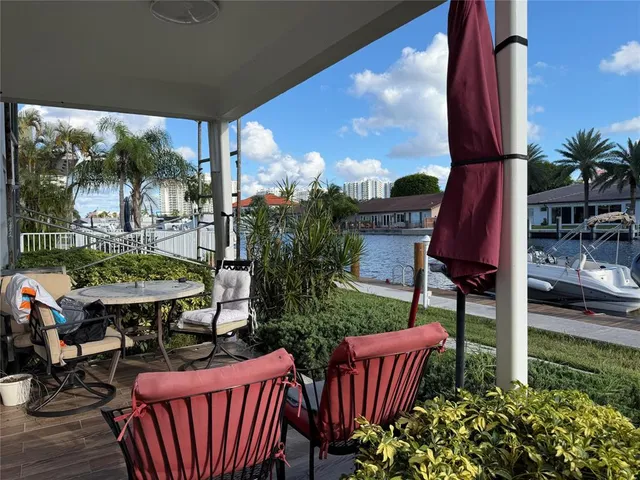 a building outdoor space with patio furniture and potted plants