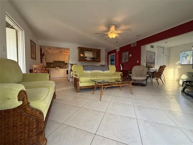 a living room with furniture and a lamp