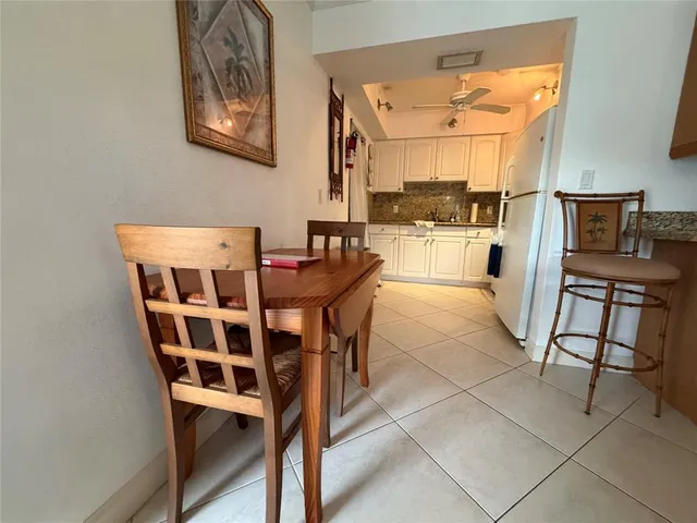 a kitchen with stainless steel appliances granite countertop a refrigerator sink and white cabinets