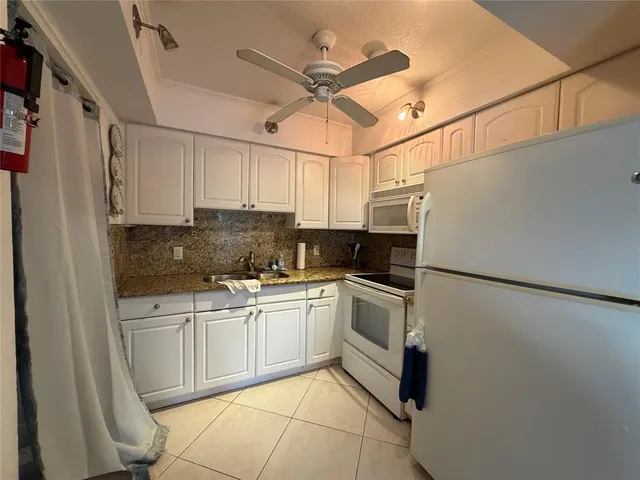 a kitchen with a sink a table and chairs
