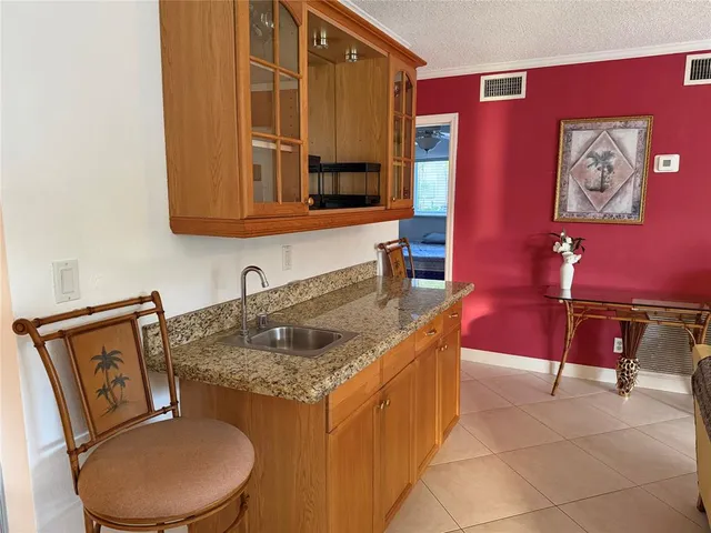 a bedroom with a bed and a flat tv screen on the dresser