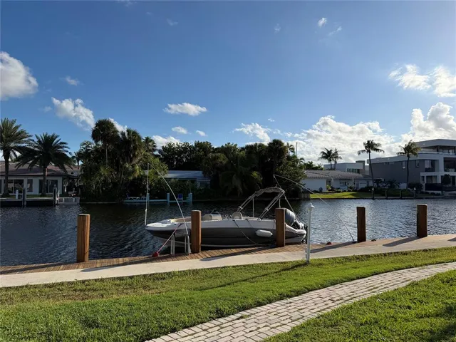 a view of a house with swimming pool and sitting area
