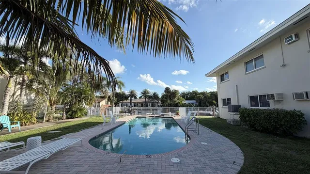 a view of a chairs and table on the roof deck