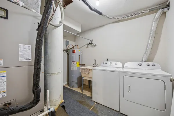 a view of backyard with barbeque grill and wooden fence