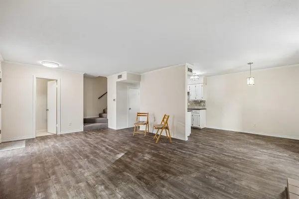 a view of kitchen with refrigerator stove and wooden cabinets