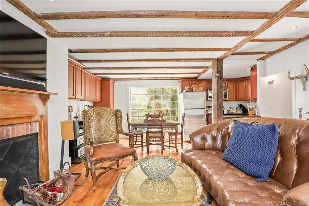 49 Hollow Tree Ridge Road Darien, CT 06820 - Photo 6 of 25 #49 - Main Level LR with Fireplace, dining area and Kitchen