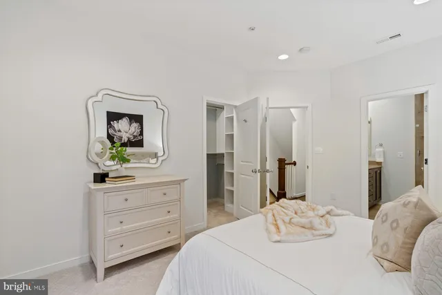 a bedroom with a bed and a dresser