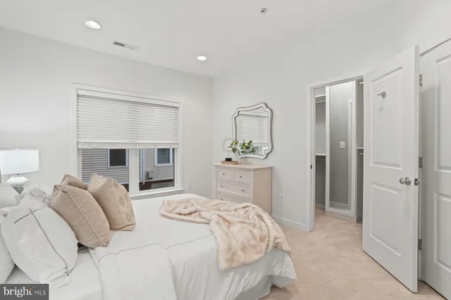 a bedroom with a bed and a mirror