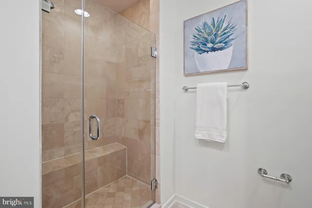 a bathroom with a painting and a shower