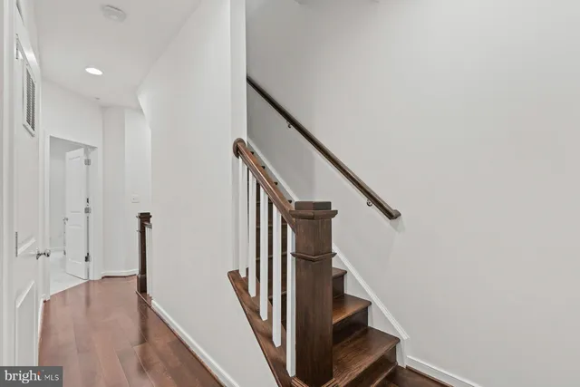 a view of entryway with wooden floor and stairs