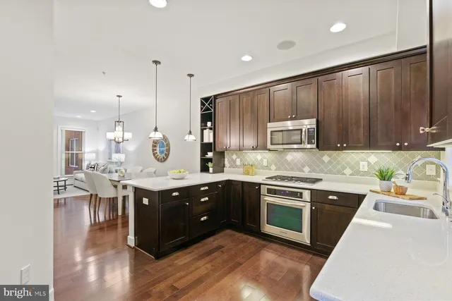 a kitchen with a sink stove and cabinets
