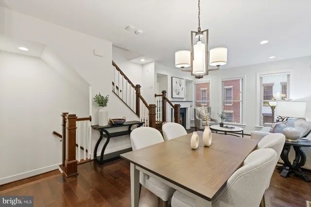 a living room with dining table and wooden floor