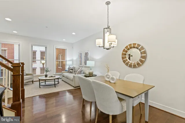 a view of a dining room with furniture wooden floor and chandelier