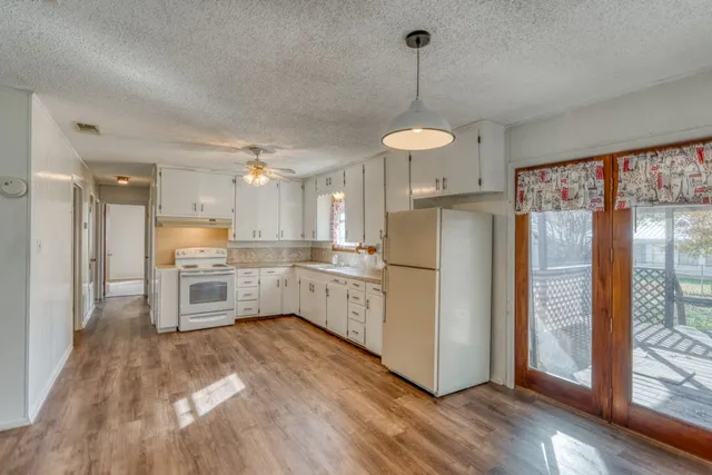 an empty room with windows and entrance