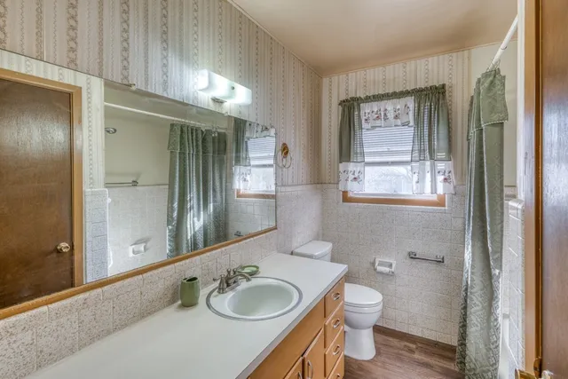 a view of hallway with wooden floor and stairs