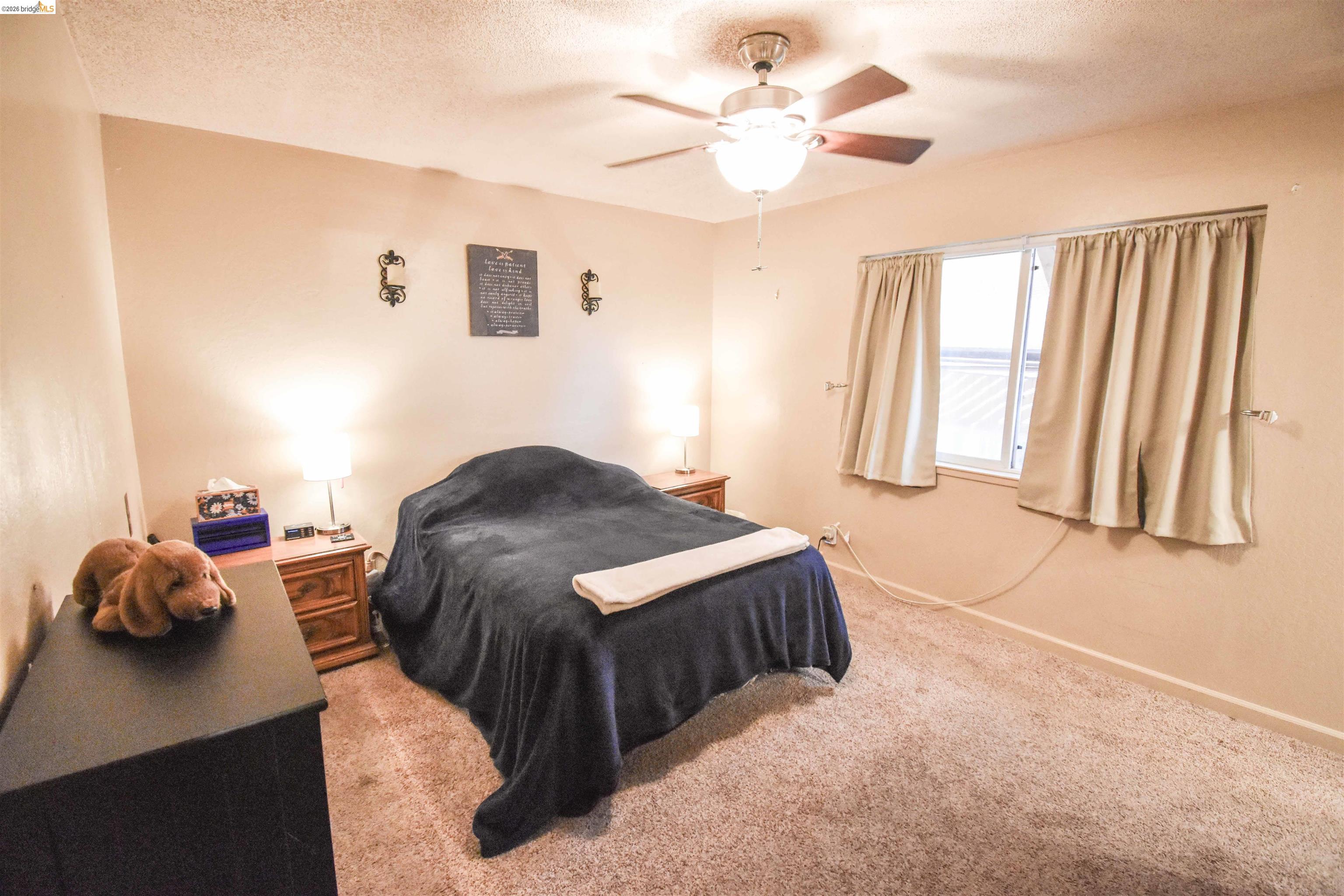 10569 Jim Brady Road Jamestown, CA 95327 - Photo 11 of 21 a bedroom with a bed and a chandelier