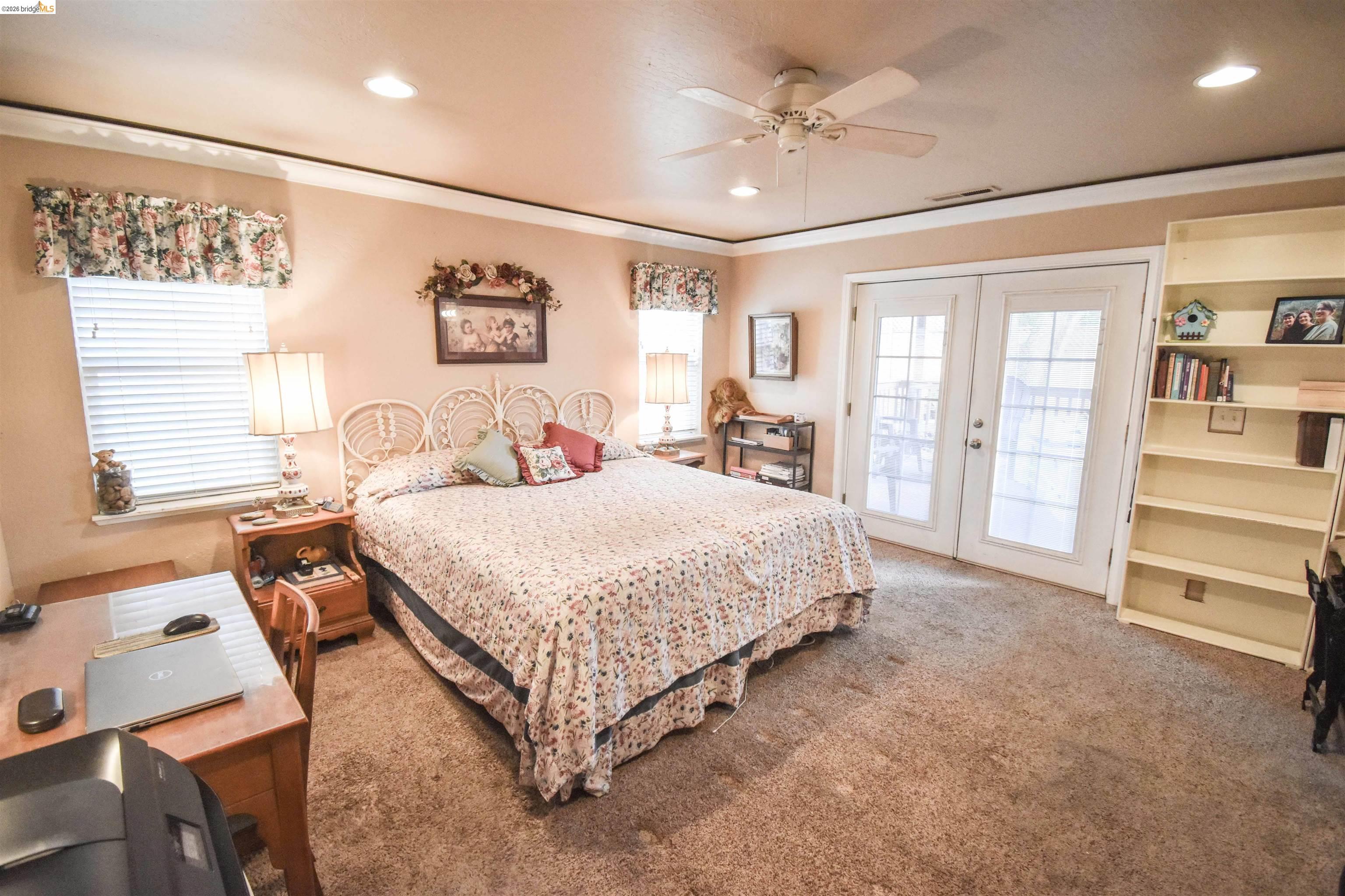 10569 Jim Brady Road Jamestown, CA 95327 - Photo 13 of 21 a spacious bedroom with a bed a dresser and a large window