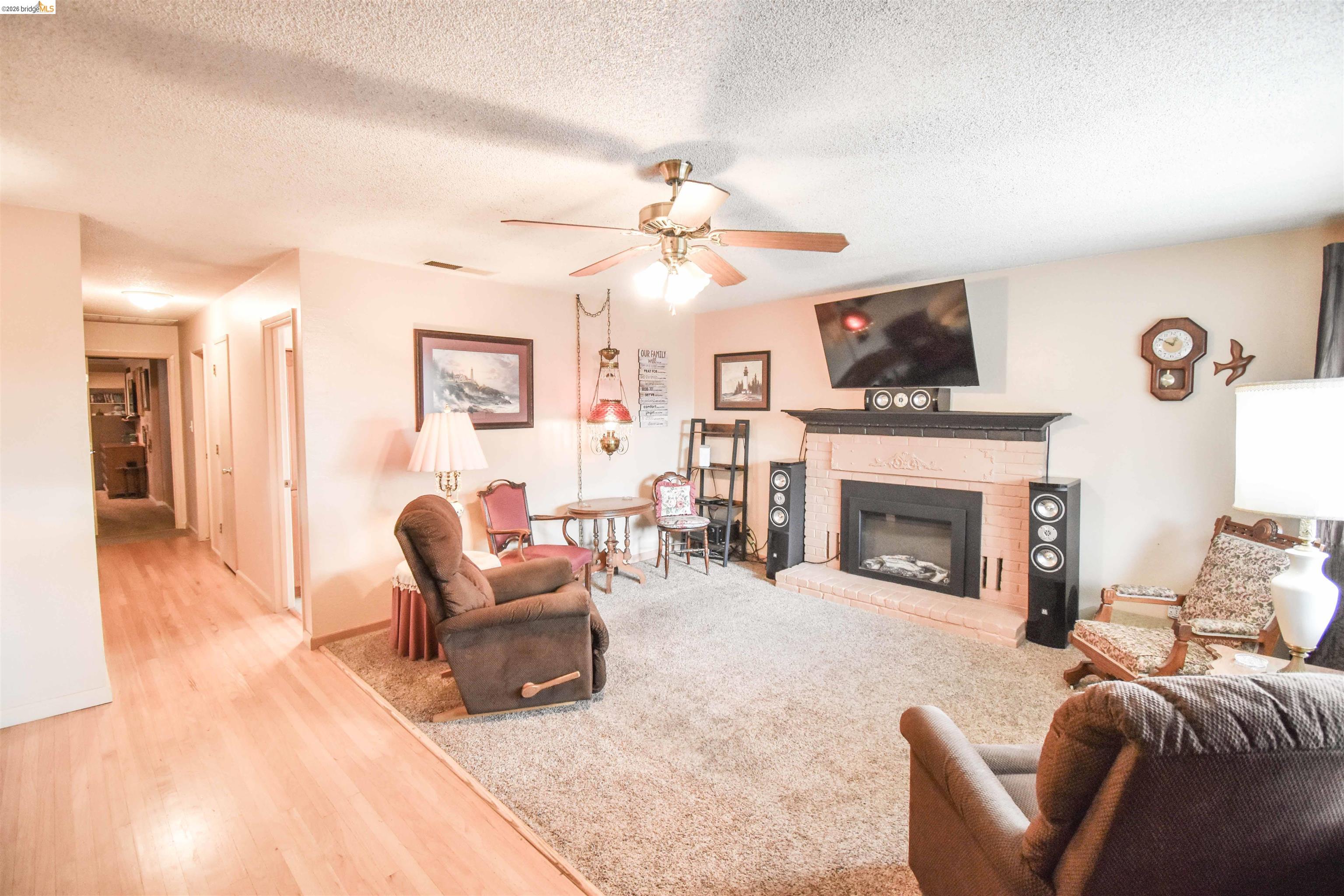 10569 Jim Brady Road Jamestown, CA 95327 - Photo 4 of 21 a living room with furniture a fireplace and a flat screen tv