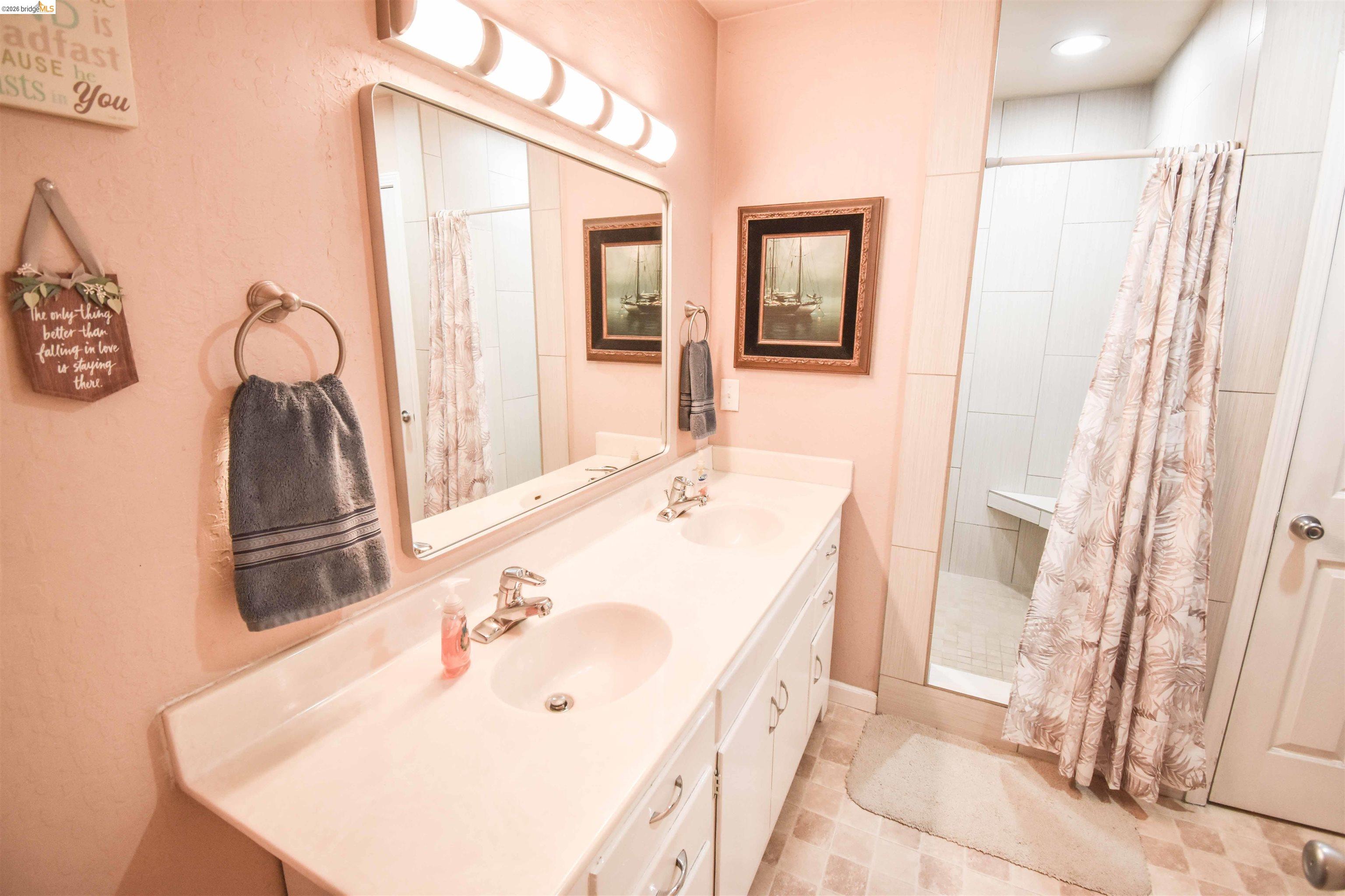 10569 Jim Brady Road Jamestown, CA 95327 - Photo 8 of 21 a bathroom with a tub sink and mirror
