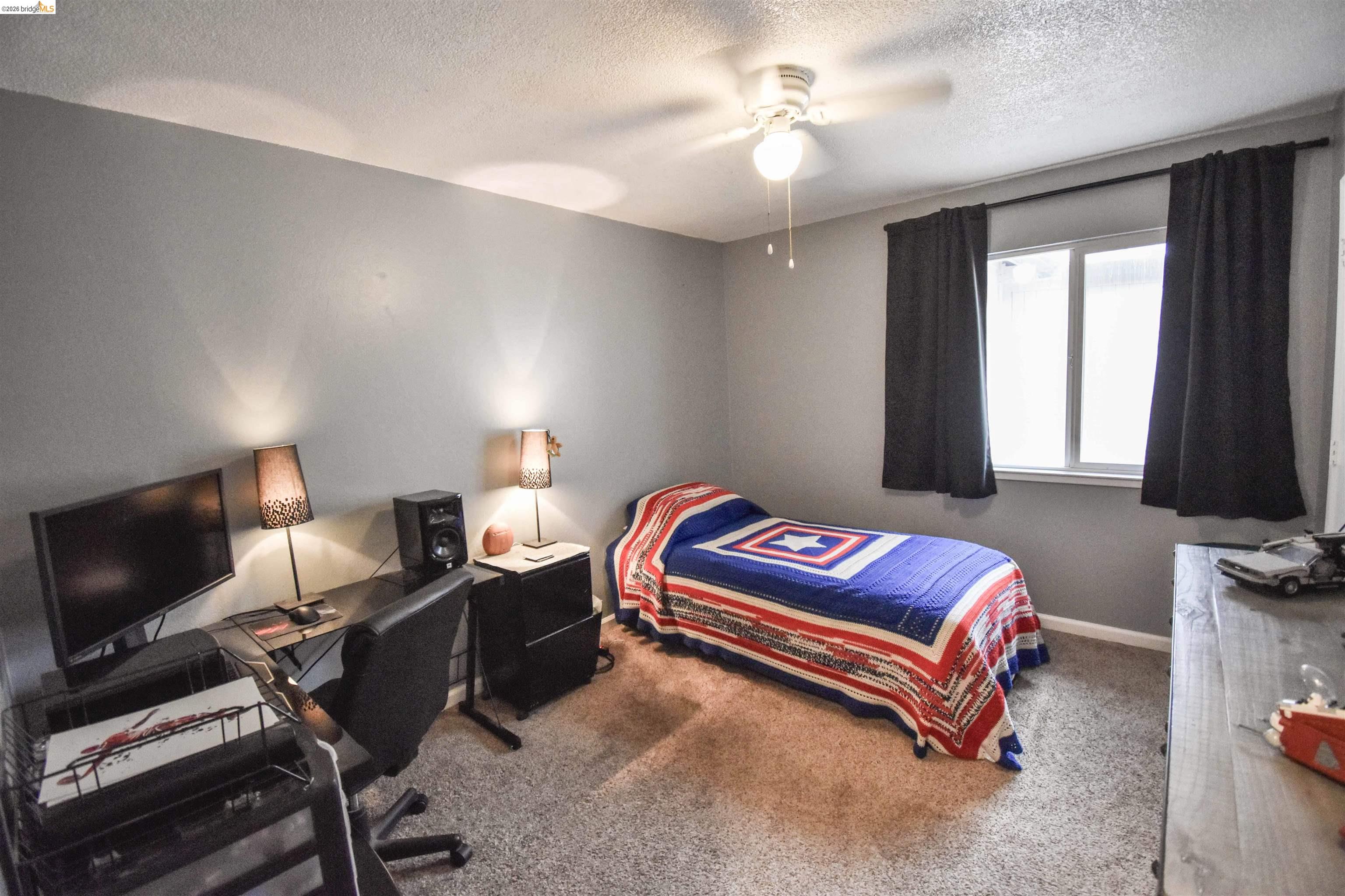 10569 Jim Brady Road Jamestown, CA 95327 - Photo 9 of 21 a bedroom with furniture and a flat screen tv