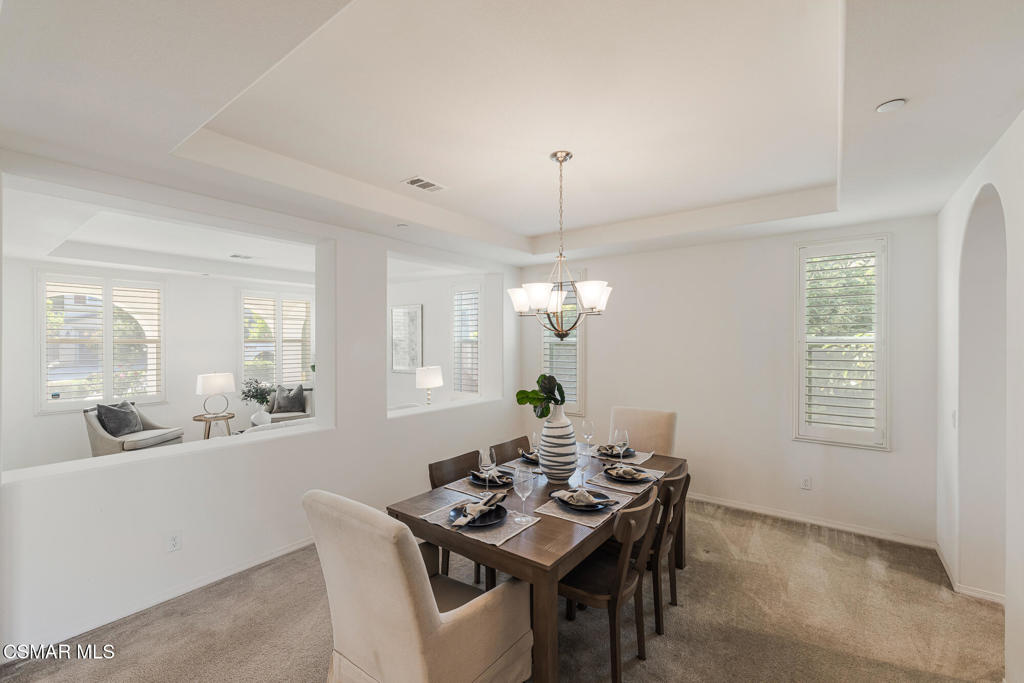 7020 Highgrove Place Moorpark, CA 93021 - Photo 12 of 59 a view of a dining room with furniture and chandelier