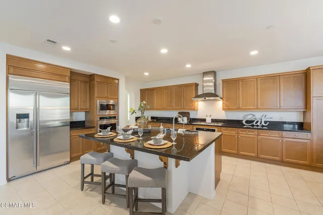 a kitchen with a table chairs sink and cabinets