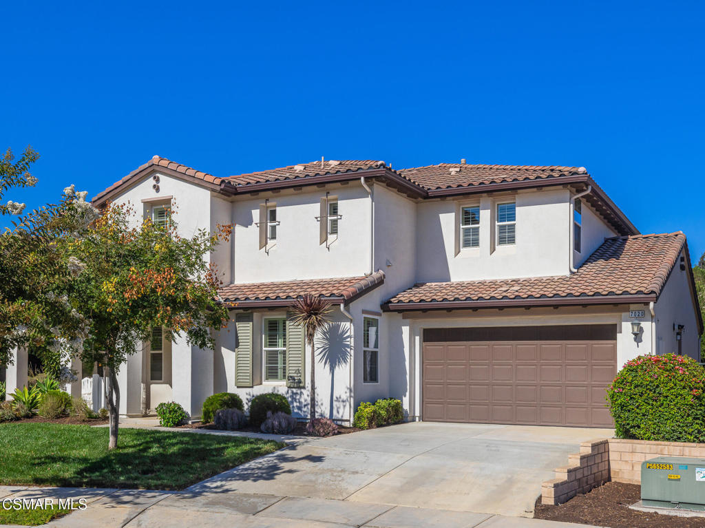7020 Highgrove Place Moorpark, CA 93021 - Photo 2 of 59 a front view of a house with a yard and garage