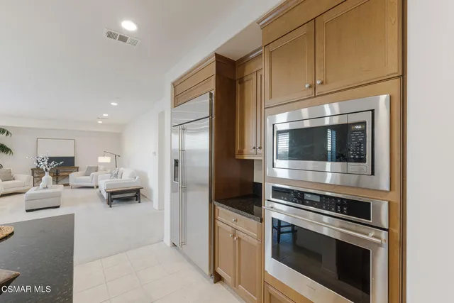a living room with furniture and a gym machine with the view of living room