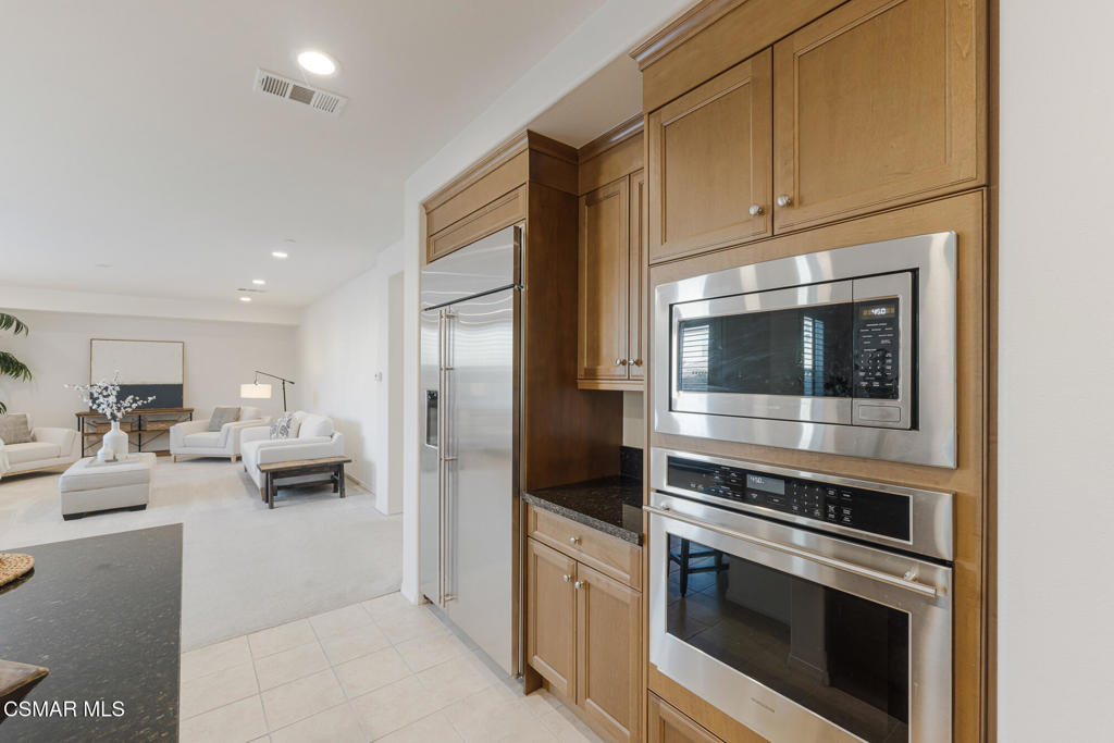 7020 Highgrove Place Moorpark, CA 93021 - Photo 22 of 59 a kitchen with stainless steel appliances kitchen island granite countertop a stove and cabinets