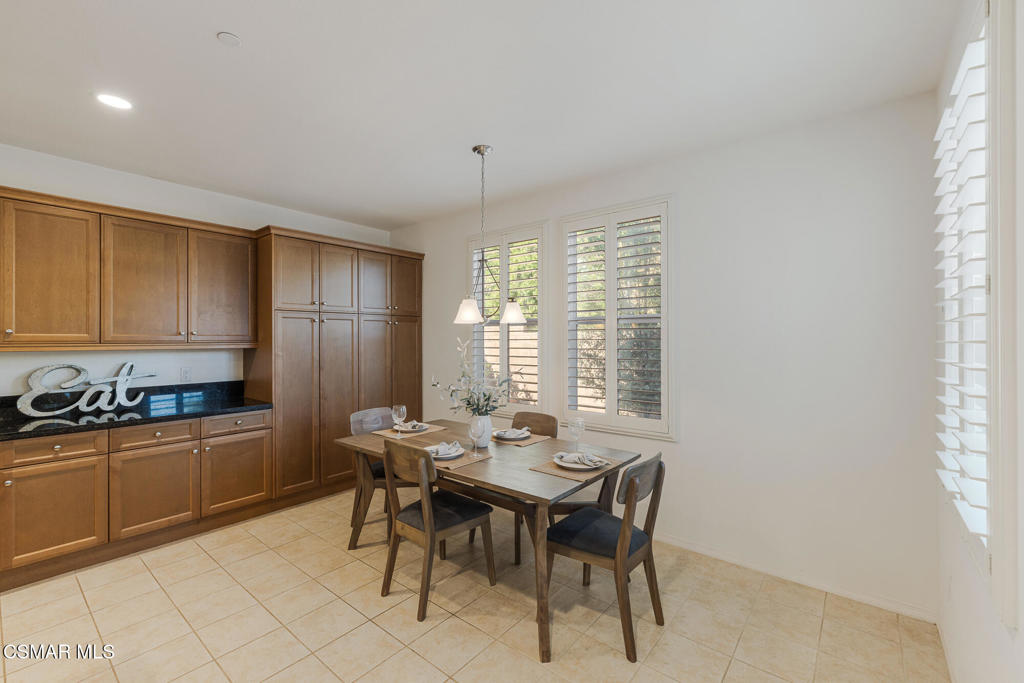 7020 Highgrove Place Moorpark, CA 93021 - Photo 23 of 59 a kitchen with a table chairs sink and cabinets