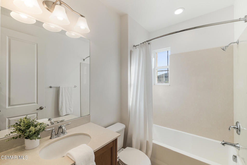 7020 Highgrove Place Moorpark, CA 93021 - Photo 38 of 59 a bathroom with a sink vanity granite tub shower and a mirror
