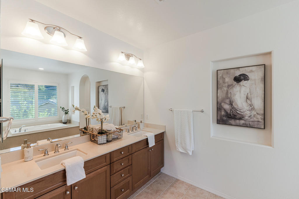 7020 Highgrove Place Moorpark, CA 93021 - Photo 42 of 59 a bathroom with a double vanity sink and a mirror