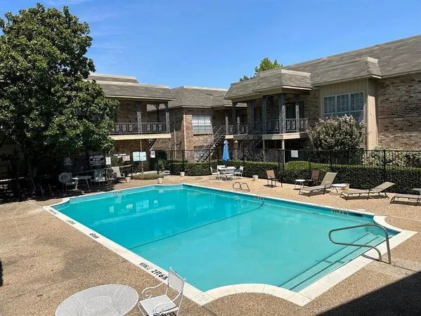 a view of a house with swimming pool and furniture