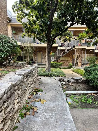 a front view of house with yard and trees