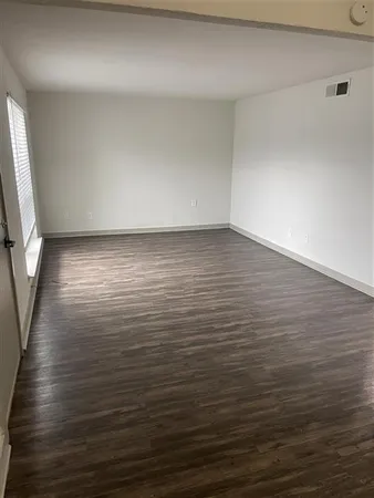 a view of room with wooden floor