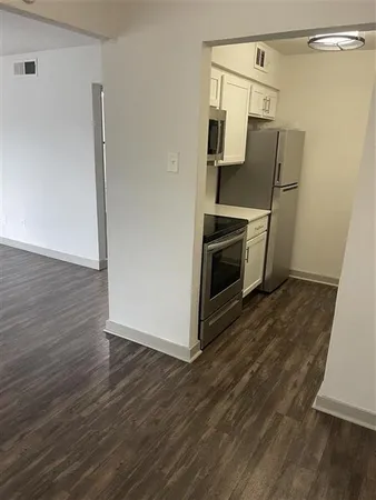 a kitchen with granite countertop a refrigerator and a stove