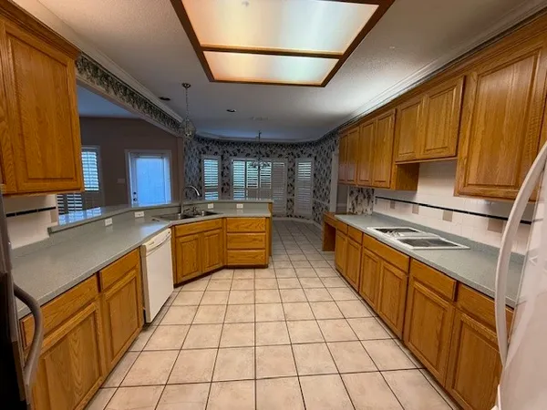 a kitchen with stainless steel appliances a sink stove and cabinets