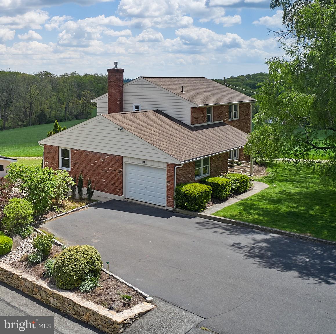 91 Nuss Road Bechtelsville, PA 19505 - Photo 2 of 7 a aerial view of a house with a yard and garage