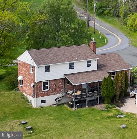 91 Nuss Road Bechtelsville, PA 19505 - Photo 3 of 7 a aerial view of a house with a yard table and chairs