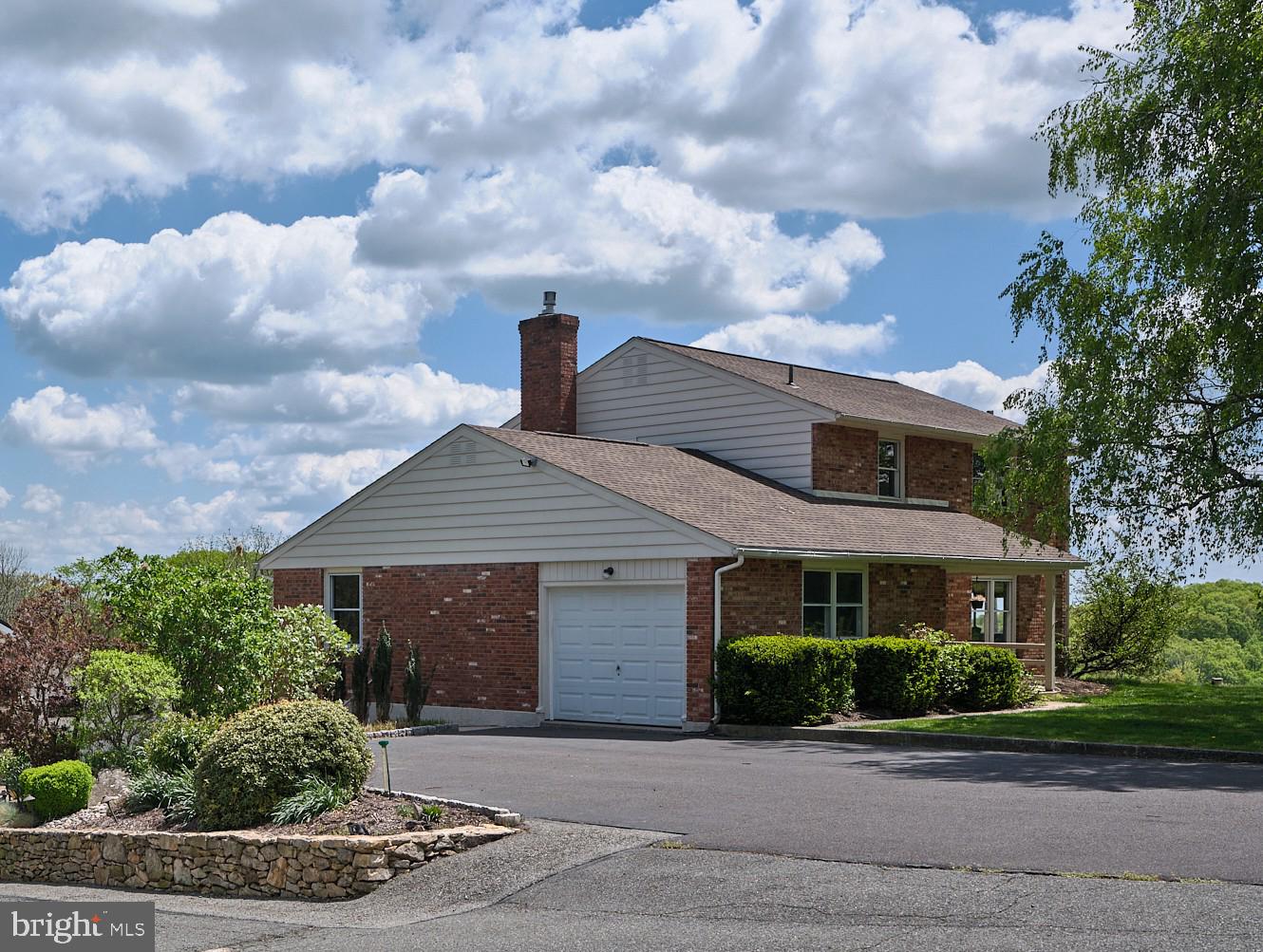 91 Nuss Road Bechtelsville, PA 19505 - Photo 4 of 7 a front view of a house with garden