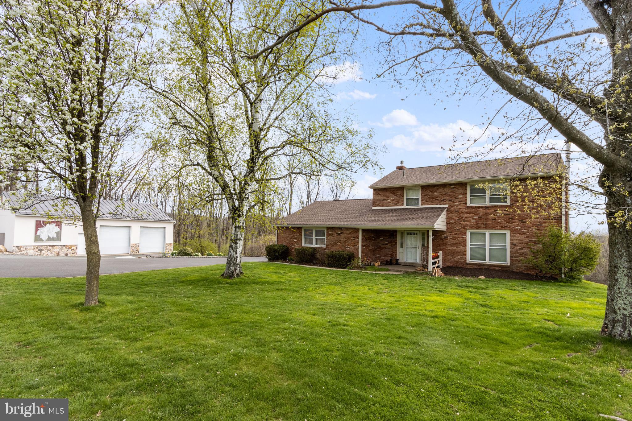 91 Nuss Road Bechtelsville, PA 19505 - Photo 7 of 7 a view of a house with a big yard and large trees
