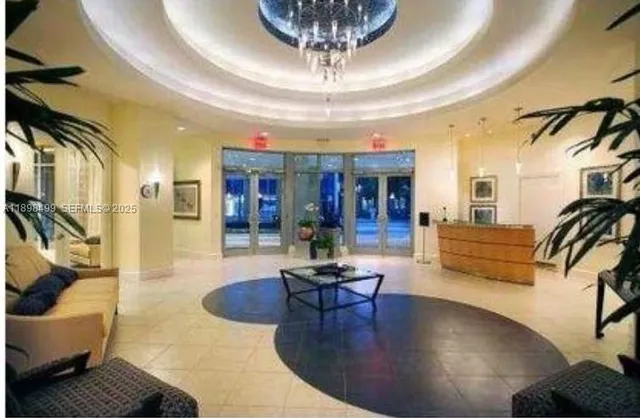 a living room with furniture and a chandelier