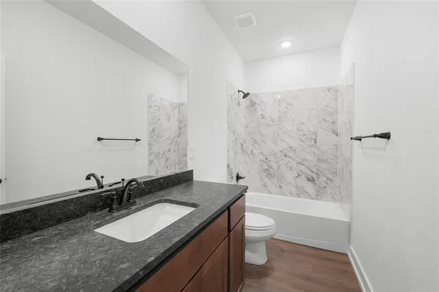 a bathroom with a granite countertop sink mirror and double
