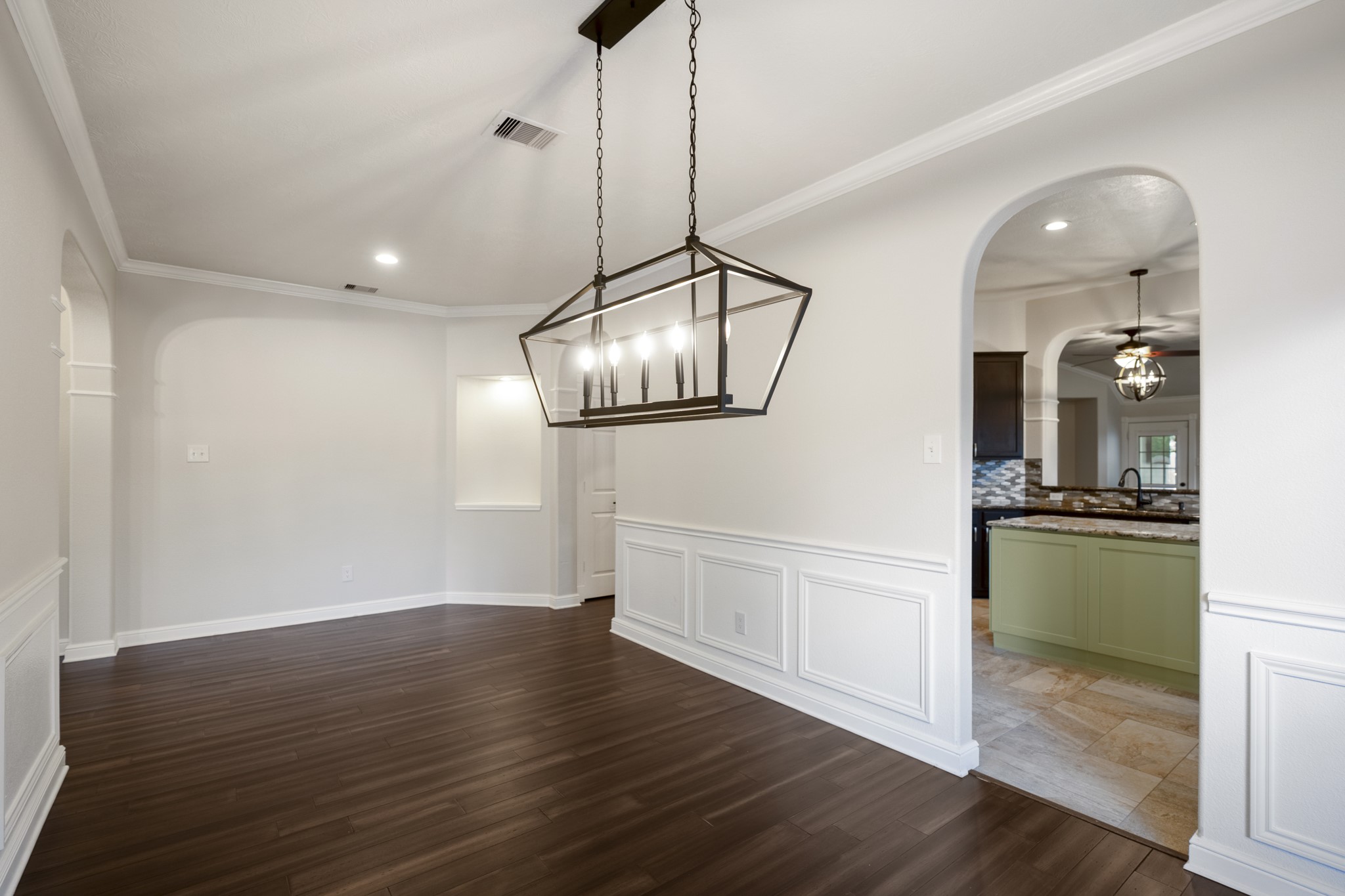 5802 Sawyer Bend Lane Spring, TX 77379 - Photo 7 of 50 a view of a kitchen with a sink wooden floor and a floor to ceiling window