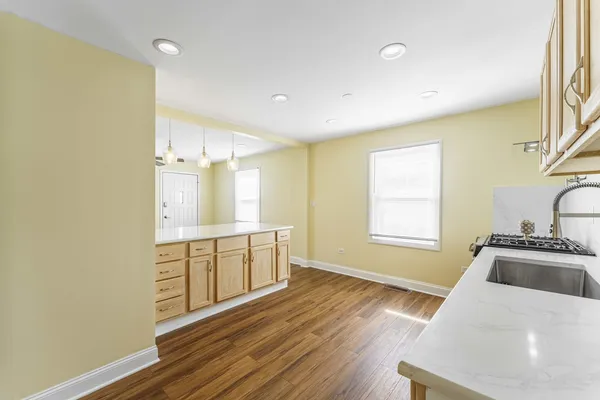 a dining room with furniture and a wooden floor