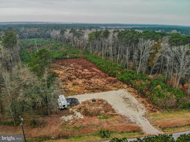 a view of a yard with wooden fence