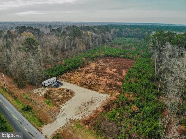 a view of a yard with wooden fence
